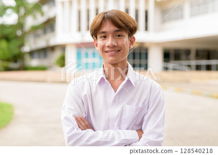 Non binary university student in college campus Non binary university student in college campus 128540218
