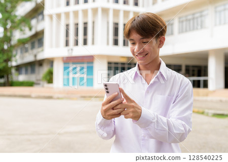 University student using phone in campus University student using phone in campus 128540225