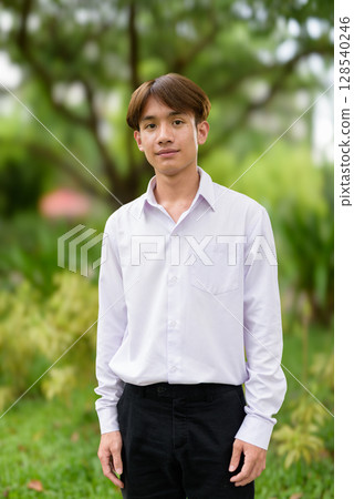 Non binary university student in college campus Non binary university student in college campus 128540246