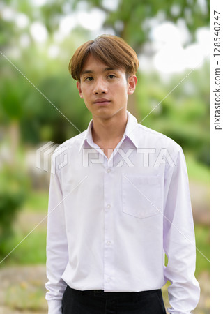 Non binary university student in college campus 128540247