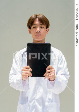 Young healthcare worker wearing lab coat 128540294