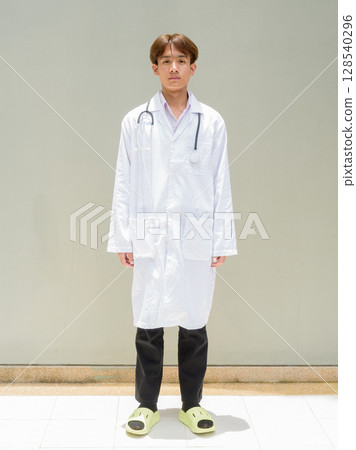 Young healthcare worker wearing lab coat full length portrait Young healthcare worker wearing lab coat full length portrait 128540296
