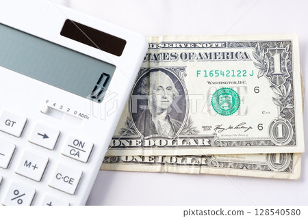1 dollar bill - United States dollar (US$) bill with first president "George Washington" and white calculator 128540580