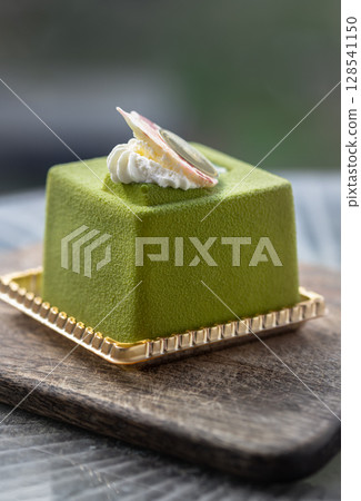 Homemade matcha tiramisu decorated with whipped cream. 128541150