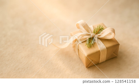 Eco Gift Box Wrapped In Kraft Paper With Ribbon And Fir Twig On Beige Fabric For Christmas Holiday Packaging Visuals. Concept Of Sustainable Wrapping, Zero Waste Celebration, And Eco-Friendly Gifting 128541158