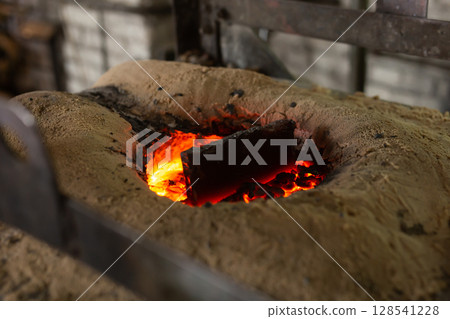 Ferrous metal billet is melted in an induction furnace closeup 128541228