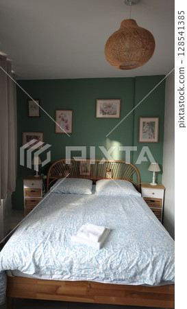 Relaxing bedroom retreat with soft colors and natural decor inviting peaceful slumber 128541385