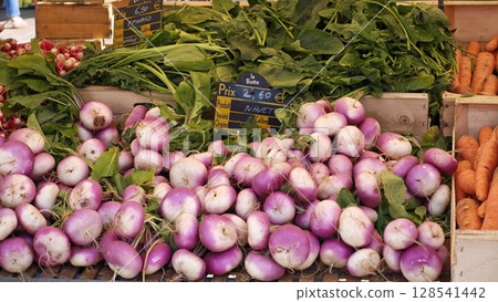 Vibrant display of fresh radishes and carrots at a local market in springtime, celebrating the colors and flavors of seasonal produce 128541442