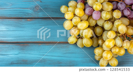 Autumn Grapes and Leaves on Blue Wooden Background Autumn Grapes and Leaves on Blue Wooden Background 128541533