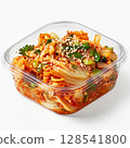 Homemade organic traditional korean kimchi cabbage salad in a plastic container on a white background . Fermented vegetarian, vegan preserved gut health food concept 128541800