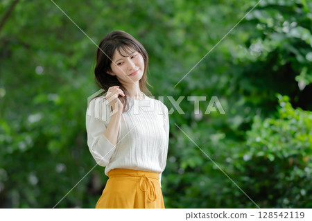 A woman relaxing in the fresh greenery A woman relaxing in the fresh greenery 128542119
