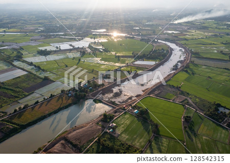 Construction dredges up for a canal and dam, to prevent a flood in the rainy season. Date on 14 May 2021 at Uthai Thani province, Thailand. 128542315