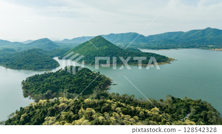 Kaeng Krachan dam with lake view and many green moutain, blue sky background. Kaeng Krachan Dam national park, Phetchaburi province, Thailand in aerial view from drone. Kaeng Krachan dam with lake view and many green moutain, blue sky background. Kaeng Krachan Dam national park, Phetchaburi province, Thailand in aerial view from drone. 128542328