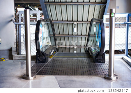 LED green light arrow Signage stainless pole in front of escalator sign the passenger the right way up and down. LED green light arrow Signage stainless pole in front of escalator sign the passenger the right way up and down. 128542347