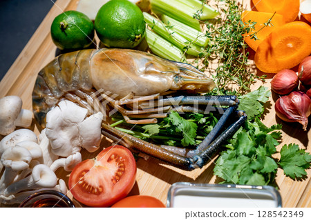 Close up the Ingredients set of TomYamKung (Shrimp Spicy Thai Soup) is a prawn, lemon condiment sauces and the others on the kitchen counter. 128542349