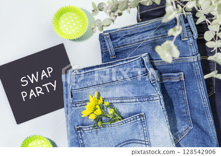 Swap Party. Jeans with flowers and blackboard with inscription Swap Party. Event for exchange of clothes, shoes and accessories. Reduce and reuse concept. Idea of exchange your old wardrobe for new Swap Party. Jeans with flowers and blackboard with inscription Swap Party. Event for exchange of clothes, shoes and accessories. Reduce and reuse concept. Idea of exchange your old wardrobe for new 128542906