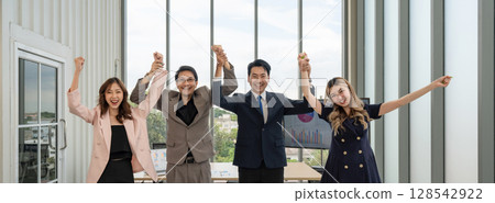 Happy business team making high hands for business teamwork concept, large group of people celebrating. 128542922