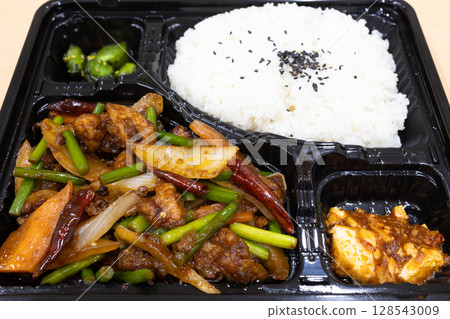 Delicious stir-fried chicken, chili peppers and vegetables Chinese lunch box 128543009