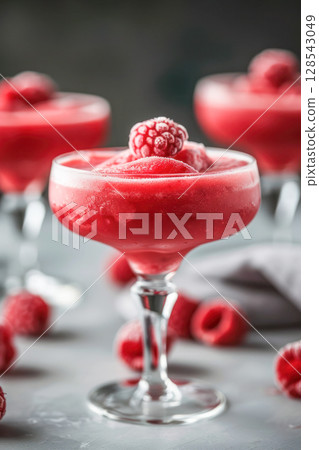 Refreshing Raspberry Daiquiri cocktail served in elegant glassware, garnished with fresh berries, perfect for summer gatherings and delightful dessert experiences Refreshing Raspberry Daiquiri cocktail served in elegant glassware, garnished with fresh berries, perfect for summer gatherings and delightful dessert experiences 128543049