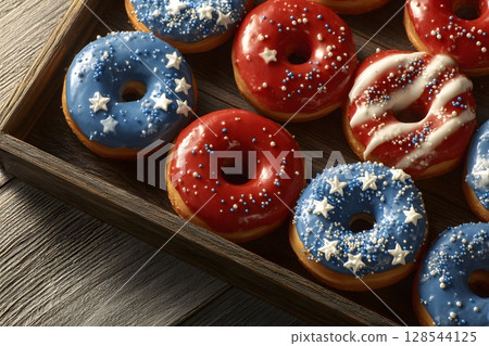 Colorful donuts decorated in red, white, and blue, featuring stars and stripes. Perfect for celebrating Independence Day and American patriotism. 128544125