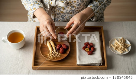 Traditional Asian Tea Ceremony with Ginseng Roots Red Dates and Herbal Ingredients 128545045