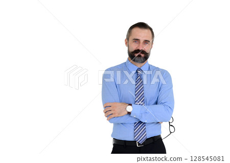 Portrait of confident middle-aged businessman in blue shirt and holding glasses with a beard and mustache standing on white background with copy space. Portrait of confident middle-aged businessman in blue shirt and holding glasses with a beard and mustache standing on white background with copy space. 128545081