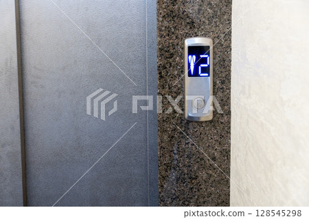 Elevator panel features a digital display indicating the second floor in a sleek, contemporary setting Elevator panel features a digital display indicating the second floor in a sleek, contemporary setting 128545298