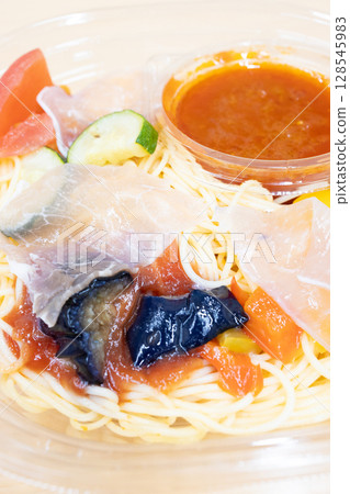 Delicious cold pasta with prosciutto and summer vegetables from a convenience store 128545983