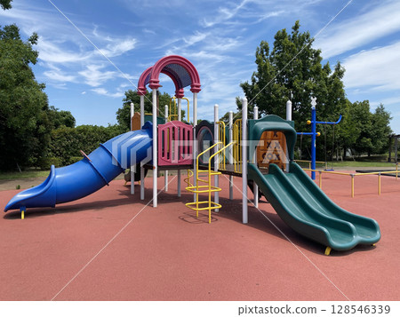 Summer park: Colorful playground equipment and blue sky 128546339