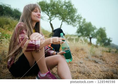 Young Woman Enjoying a Relaxing Outdoor Moment in Nature Young Woman Enjoying a Relaxing Outdoor Moment in Nature 128546598