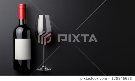Minimalist composition of red wine glass and bottle, black background 128546658