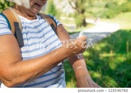 Senior Woman Enjoying a Refreshing Moment on a Nature Trail 128546760