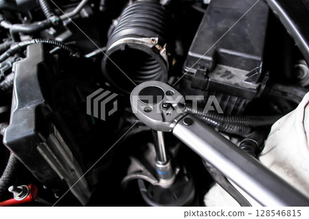 Torque wrench in use, auto repair or car maintenance and engine work with mechanic tool 128546815