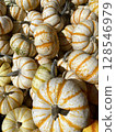 A colorful fall harvest: Ornamental pumpkins with distinctive white stripes 128546979