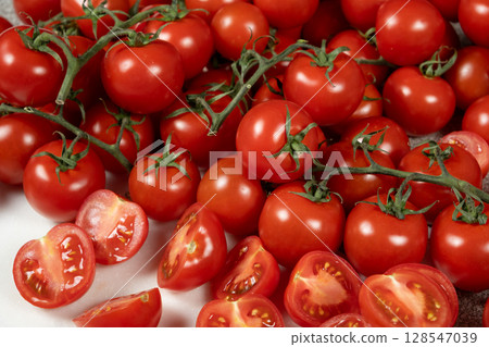 Lots of ripe fresh cocktail tomatoes close-up. 128547039