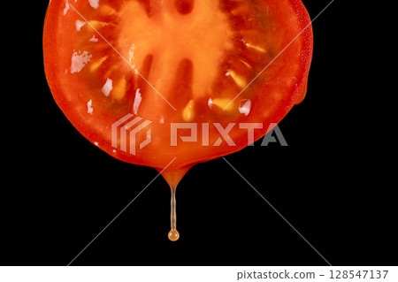 Macro Flow of Tomato Juice on Fresh Cut Tomato. Macro Flow of Tomato Juice on Fresh Cut Tomato. 128547137