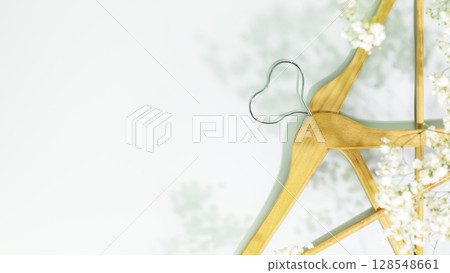 Creative spring shopping and sale concept. Wooden hangers in shape of heart with white spring flowers on blue background. Fashion spring discounts shopping, sale store. Flat lay, copy space 128548661
