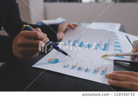 Team of business people working together in the meeting room office,teamwork background charts and graphs banner, double exposure successful teamwork,business planning concept. 128548710