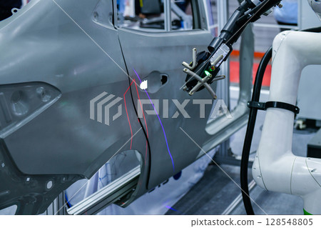 3D scanner on robotic arm measure the accuracy of automotive parts. in industrial plants 3D scanner on robotic arm measure the accuracy of automotive parts. in industrial plants 128548805