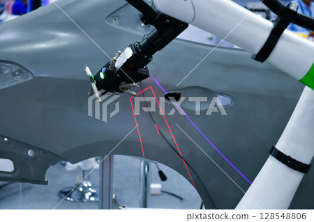 3D scanner on robotic arm measure the accuracy of automotive parts. in industrial plants 128548806