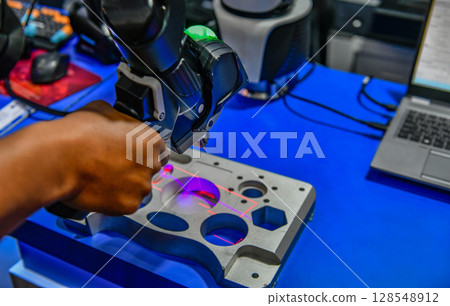 Portable 3D Auto parts handheld scanner is scanning to measure size and texture for future product development production in the automotive industry 128548912