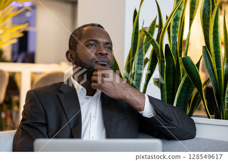 African american businessman working in the office and looking busy African american businessman working in the office and looking busy 128549617