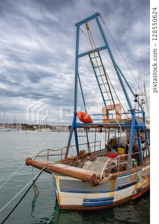 Old fishing boat moored in Novigrad harbor Croatia 128550624