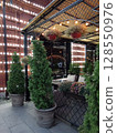 cozy veranda of an outdoor cafe in Vladikavkaz, decorated with garlands, pedestrian street Prospekt Mira 128550976