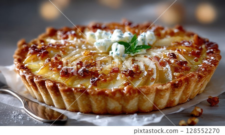 Caramelized pear tart with goat cheese and nuts, served rustic-style on parchment paper with vintage props and soft lighting. Caramelized pear tart with goat cheese and nuts, served rustic-style on parchment paper with vintage props and soft lighting. 128552270