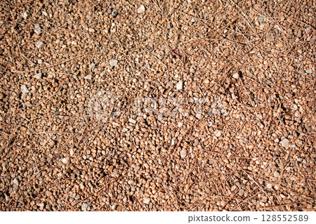 Texture of small pebbles on the ground, close-up 128552589