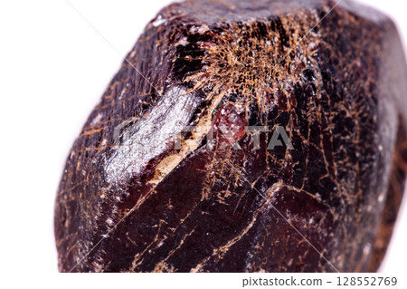 Macro of a mineral garnet stone on a white background Macro of a mineral garnet stone on a white background 128552769