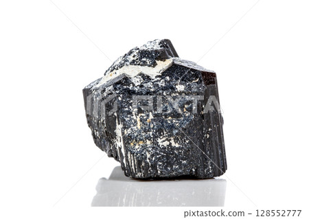 macro mineral stone sherle, schorl, black tourmaline on white background macro mineral stone sherle, schorl, black tourmaline on white background 128552777