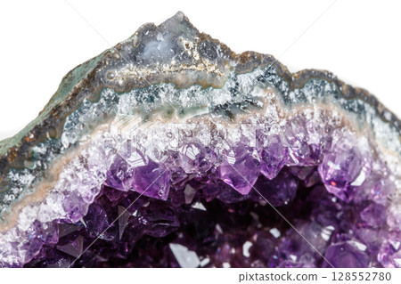 Macro Mineral Stone Amethysts in the rock on a white background Macro Mineral Stone Amethysts in the rock on a white background 128552780