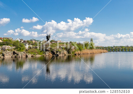 green coast of a beautiful small river with white clouds in reflection green coast of a beautiful small river with white clouds in reflection 128552810